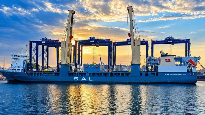 A ship carrying six blue gantry cranes arrives at Latakia Port